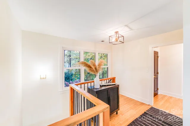 a view of entryway and hall with wooden floor
