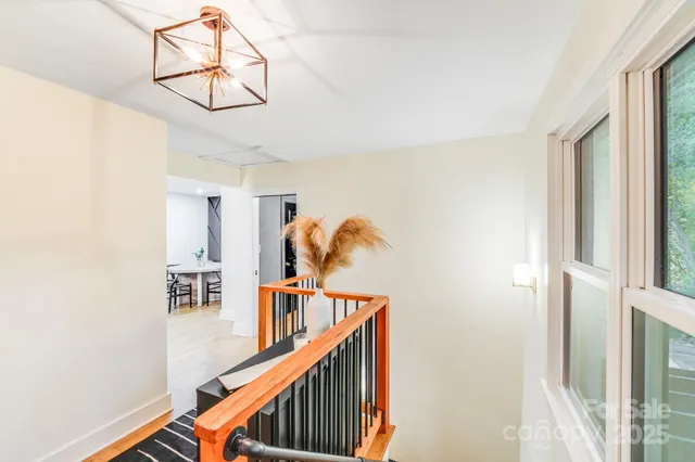 a view of entryway and hall with wooden floor