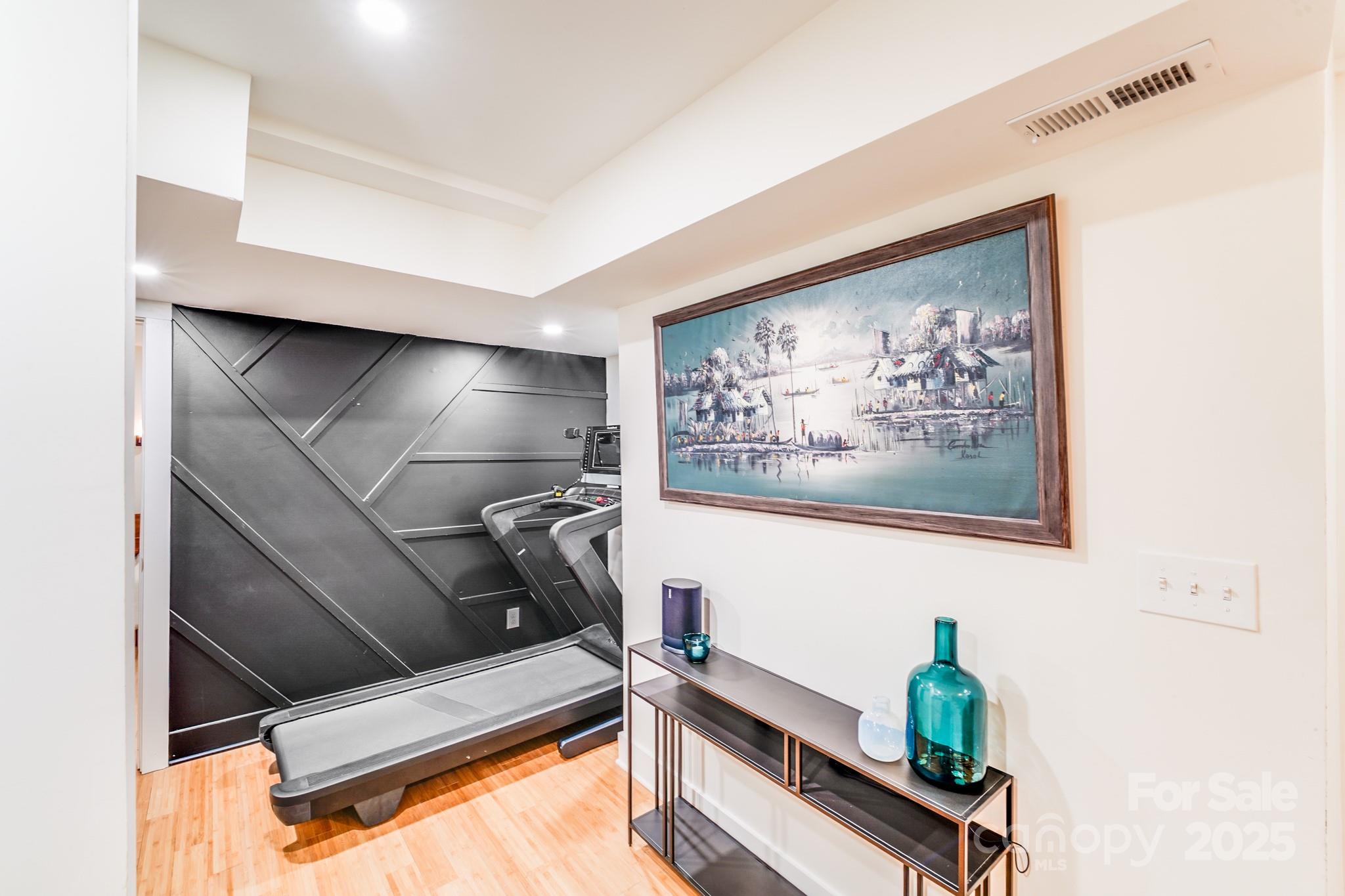 4910 Valley Stream Road Charlotte, NC 28209 - Photo 24 of 35 a room with gym equipment and potted plant