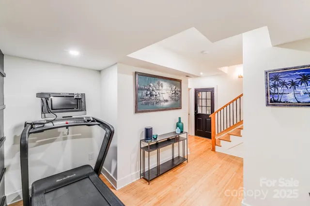 a hallway with furniture and a flat screen tv