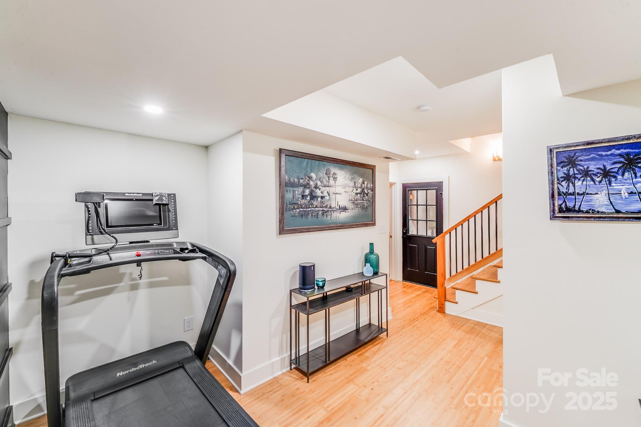 4910 Valley Stream Road Charlotte, NC 28209 - Photo 25 of 35 a hallway with furniture and a flat screen tv