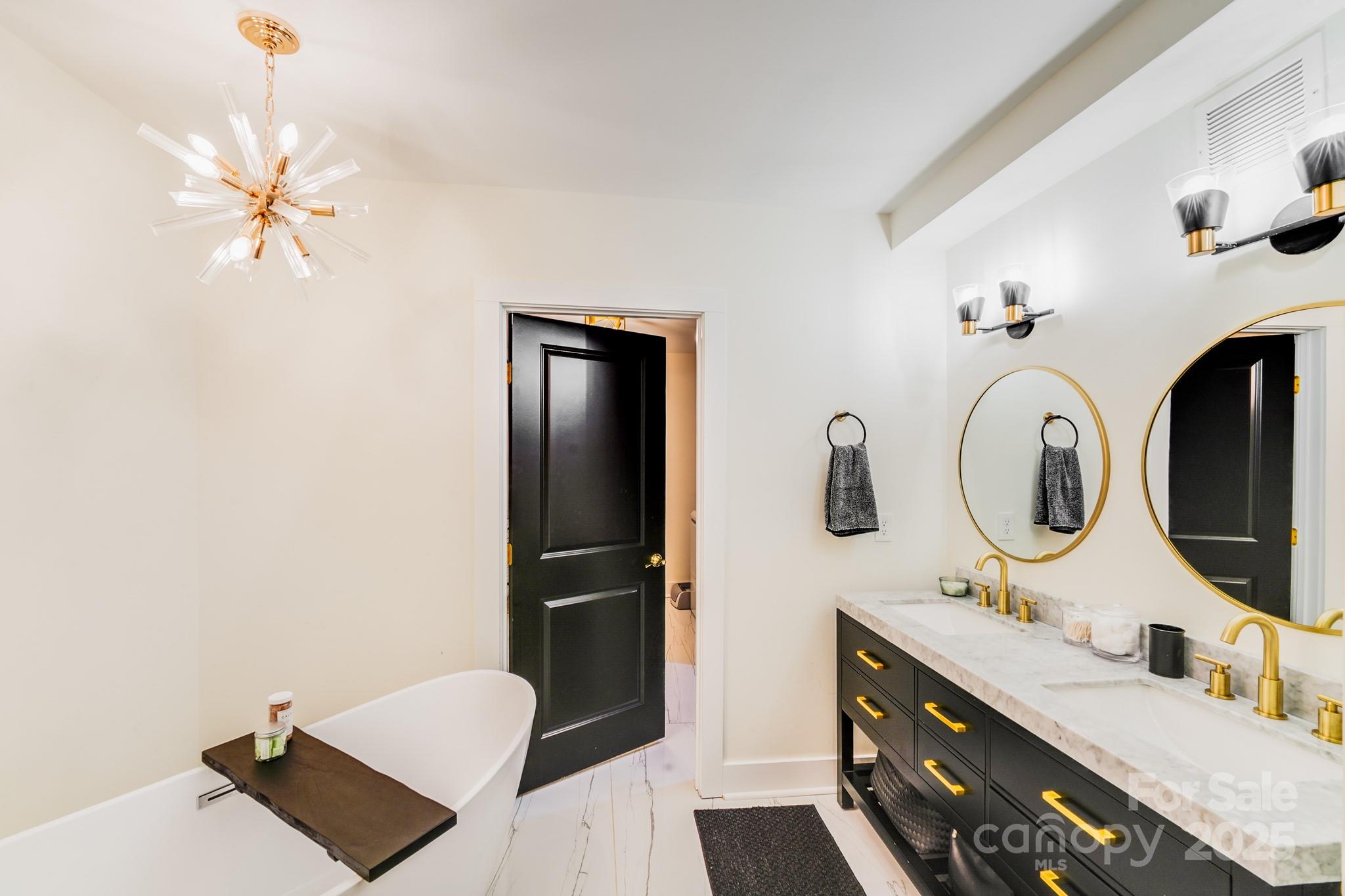 4910 Valley Stream Road Charlotte, NC 28209 - Photo 31 of 35 a bathroom with a double vanity sink and a mirror