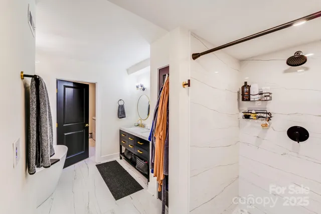 a bathroom with a shower and a mirror