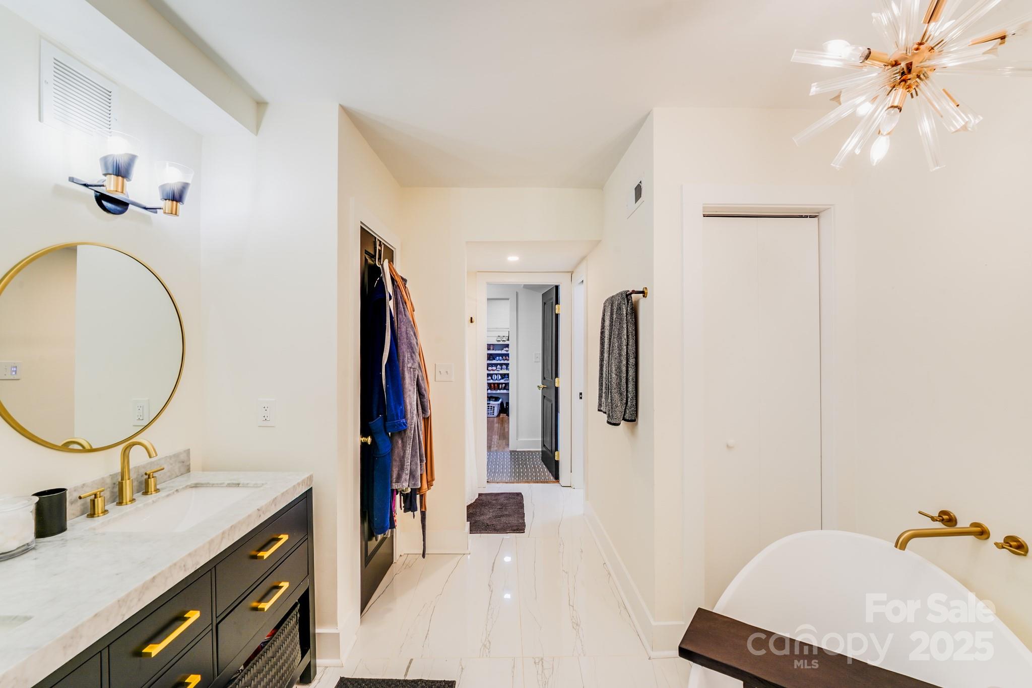 4910 Valley Stream Road Charlotte, NC 28209 - Photo 33 of 35 a bathroom with a sink a mirror and a shower