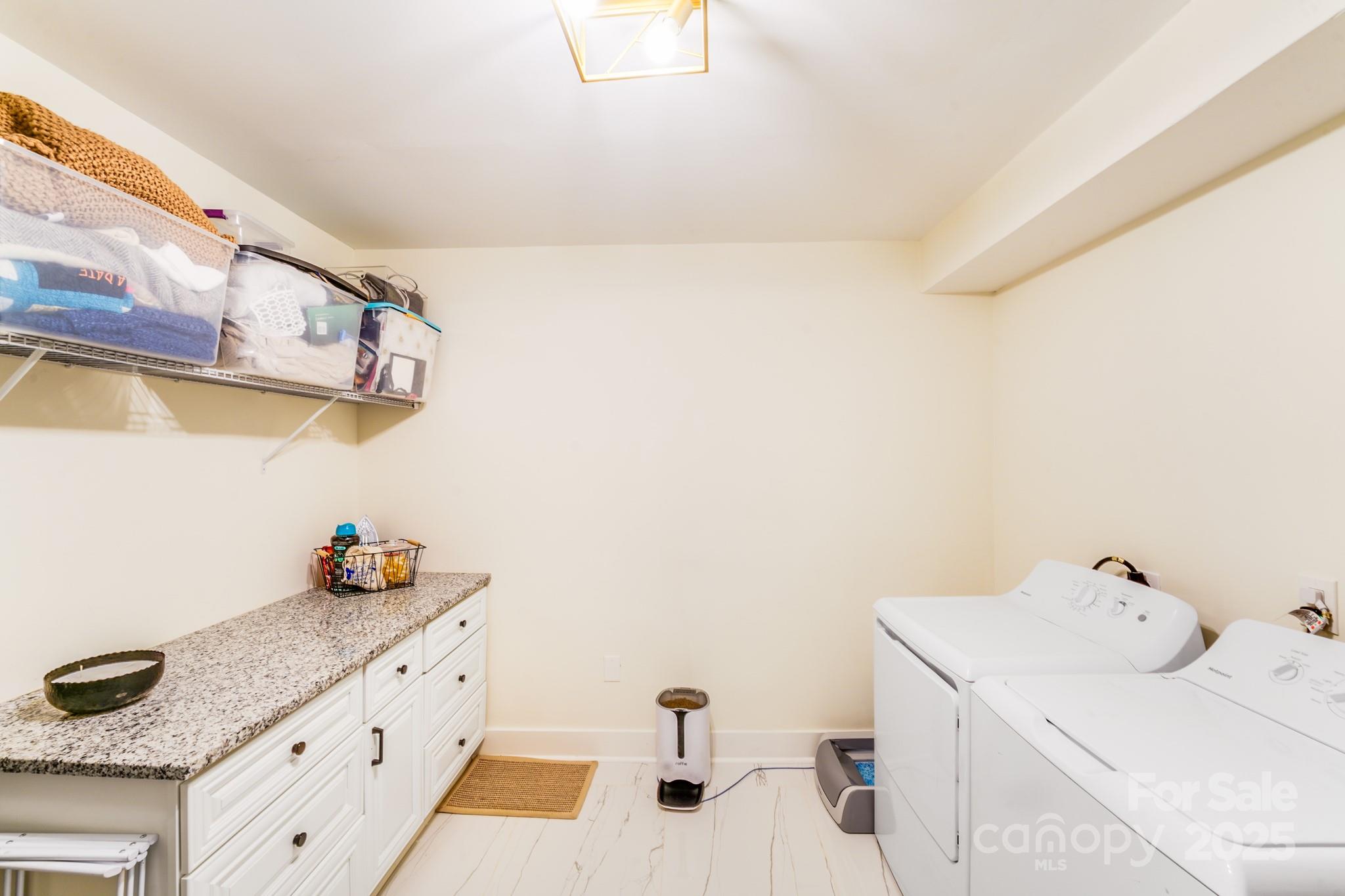 4910 Valley Stream Road Charlotte, NC 28209 - Photo 34 of 35 a bathroom with a sink and a shower curtain