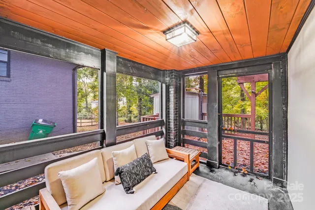a living room with furniture tv and a window