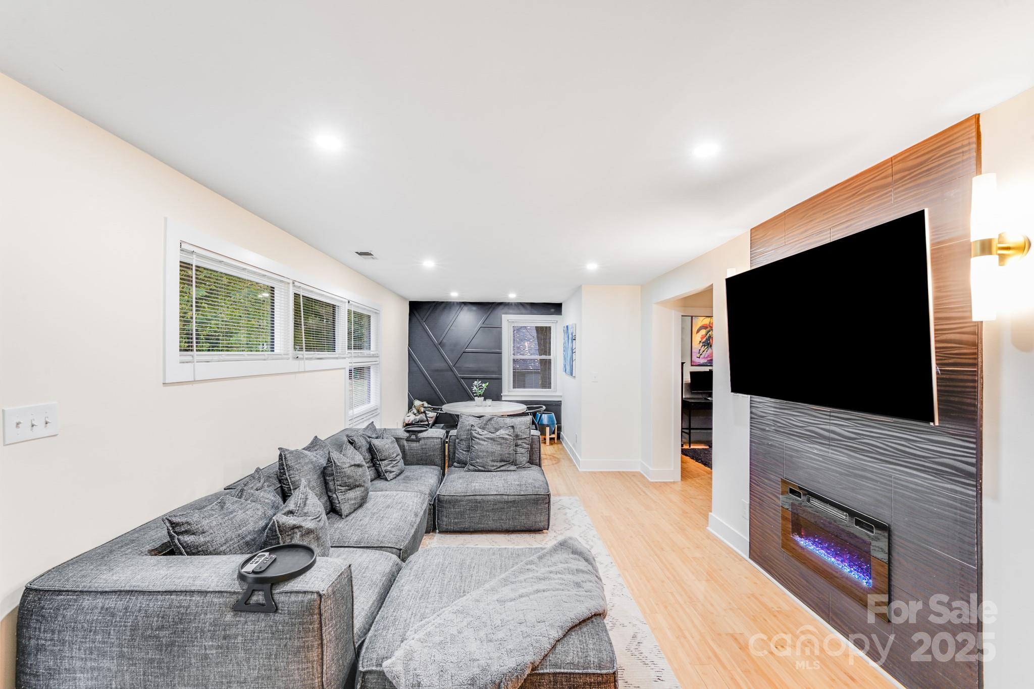 4910 Valley Stream Road Charlotte, NC 28209 - Photo 5 of 35 a living room with furniture and a flat screen tv
