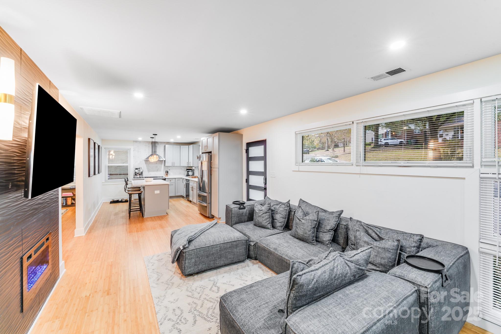4910 Valley Stream Road Charlotte, NC 28209 - Photo 9 of 35 a living room with furniture and a flat screen tv