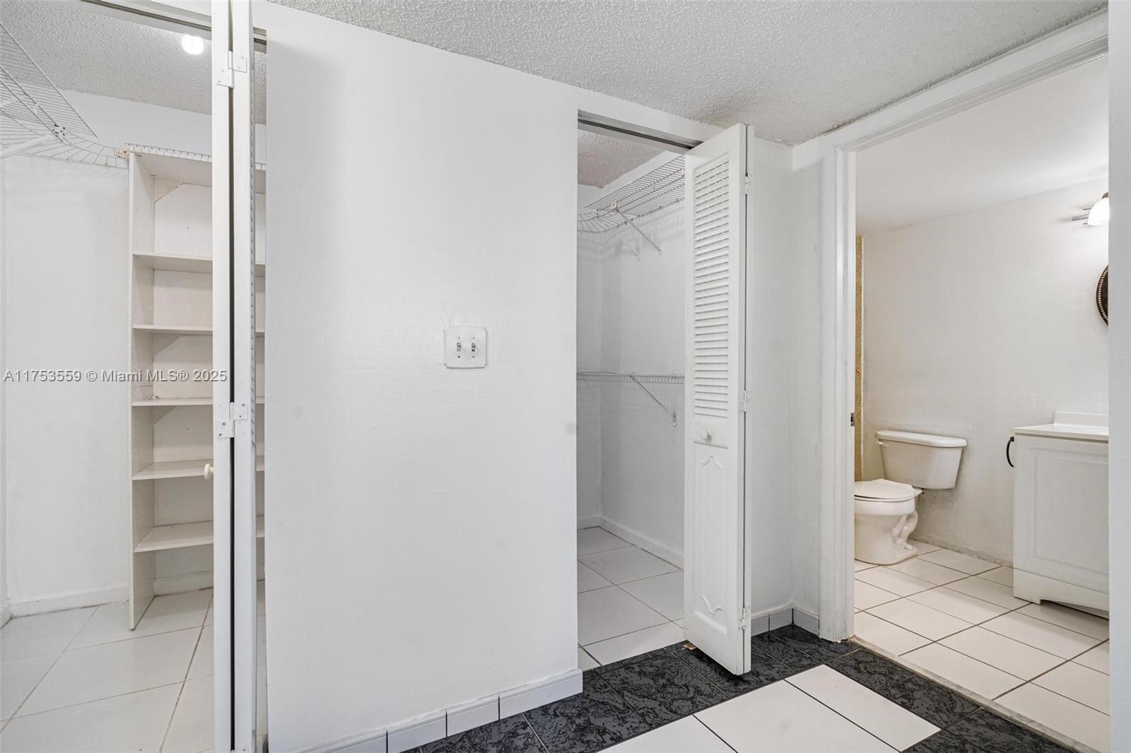 7300 Wayne Avenue, Unit 317 Miami Beach, FL 33141 - Photo 14 of 26 a bathroom with a shower and a toilet