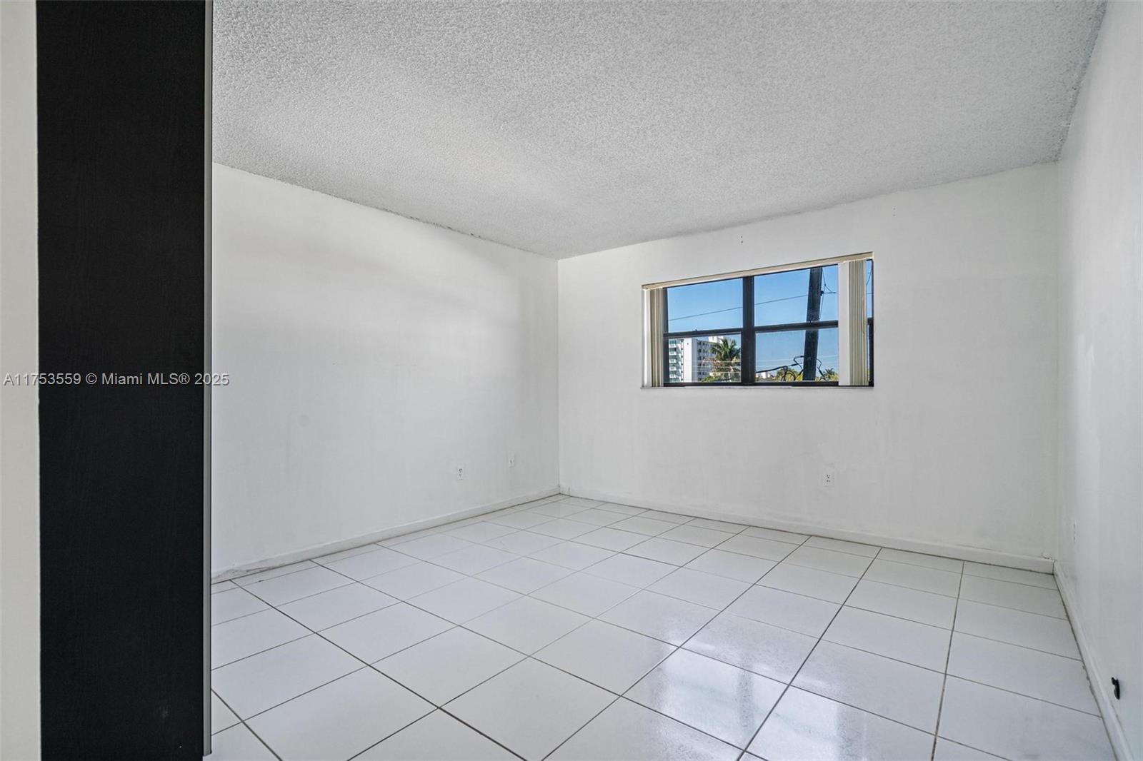 7300 Wayne Avenue, Unit 317 Miami Beach, FL 33141 - Photo 15 of 26 an empty room with windows