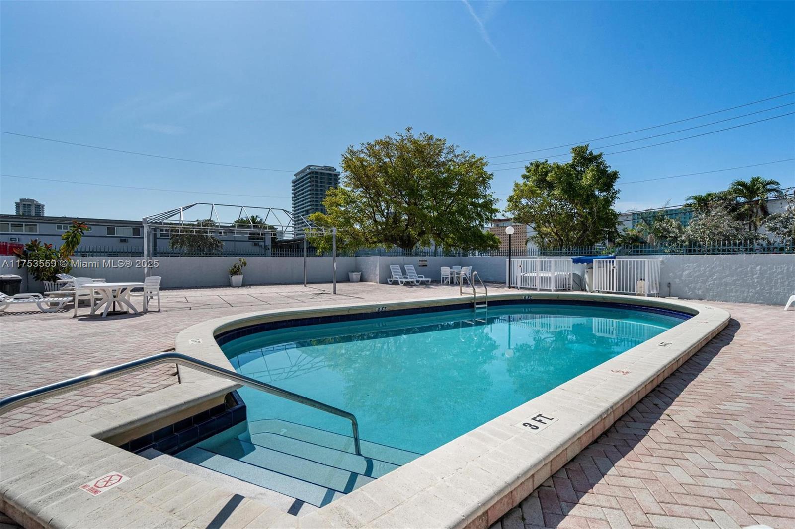 7300 Wayne Avenue, Unit 317 Miami Beach, FL 33141 - Photo 23 of 26 a view of a swimming pool with a lounge chair
