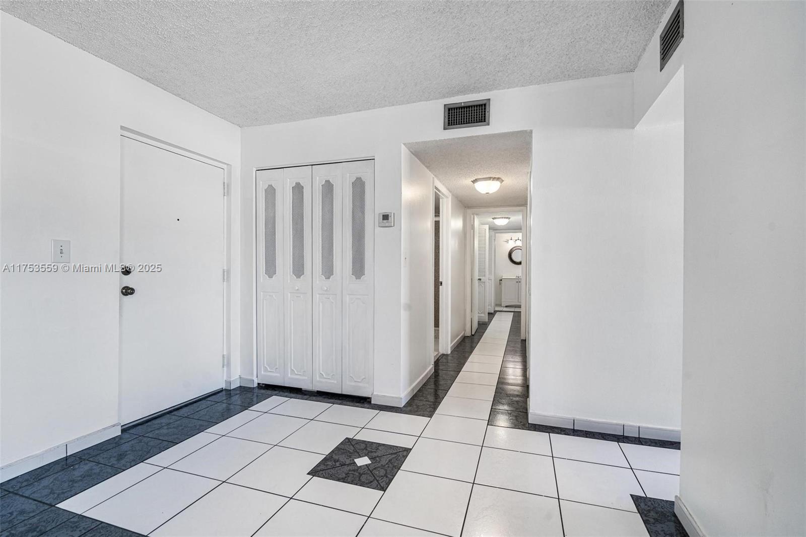 7300 Wayne Avenue, Unit 317 Miami Beach, FL 33141 - Photo 7 of 26 a view of a hallway with wooden floor and staircase
