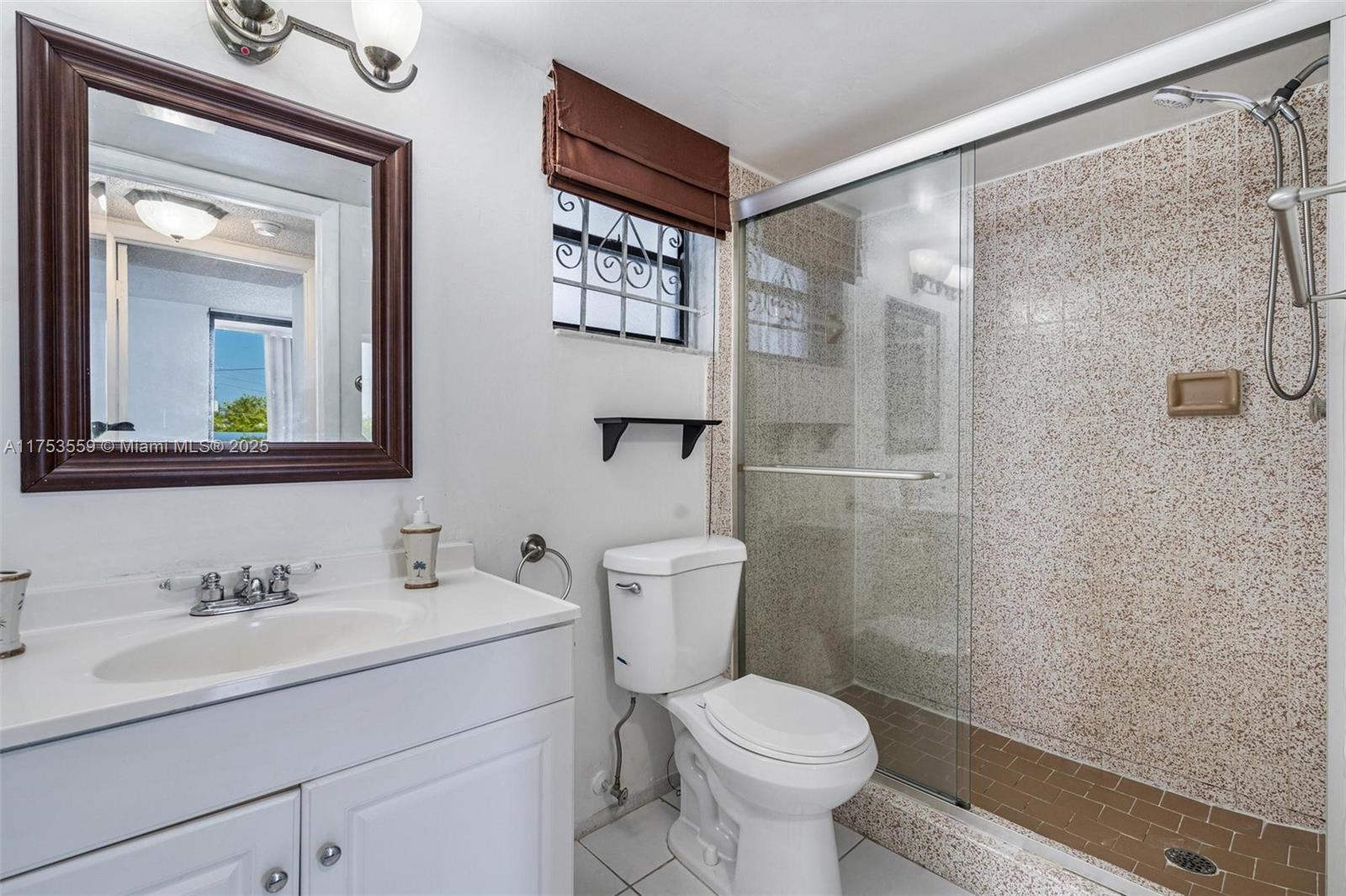 7300 Wayne Avenue, Unit 317 Miami Beach, FL 33141 - Photo 10 of 26 a bathroom with a sink a toilet and shower