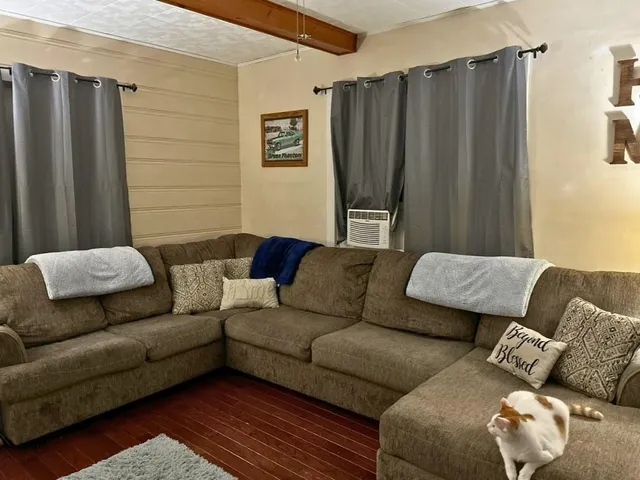 a living room with furniture and a blue wall