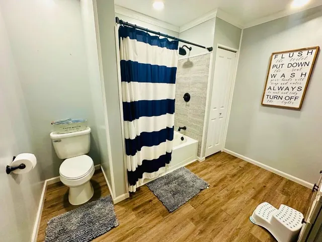 a bathroom with a toilet and a shower