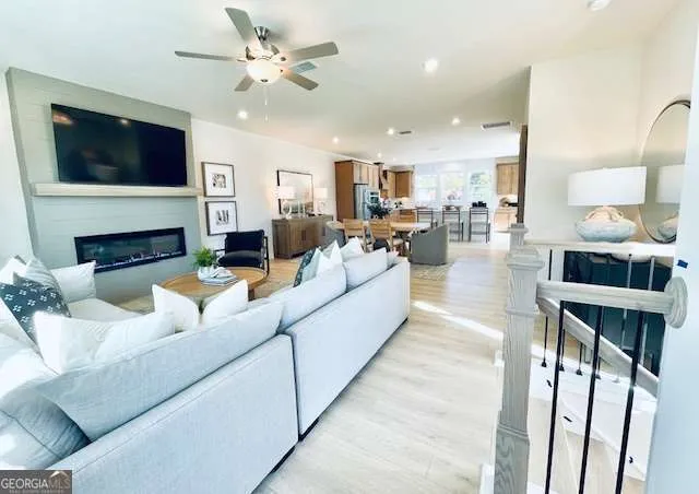 a living room with fireplace furniture and a flat screen tv