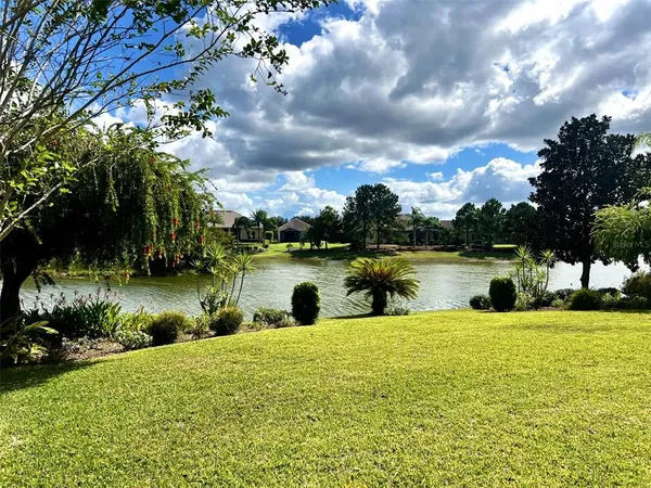 a view of a lake with houses in the back