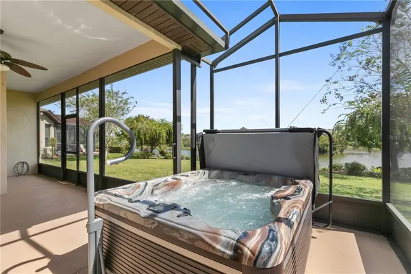 a view of a patio with table and chairs and floor to ceiling window