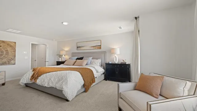 a bedroom with furniture and a flat screen tv