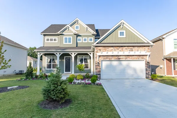 a front view of a house with a yard and garage