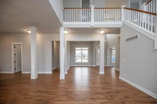 a view of living room with furniture and wooden floor