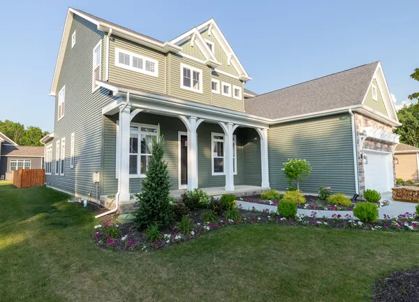 a front view of a house with garden