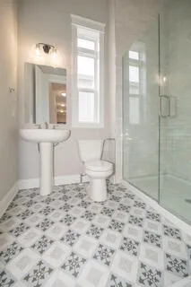 a bathroom with a double vanity sink mirror and shower