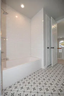 a bathroom with a double vanity sink a mirror and a shower