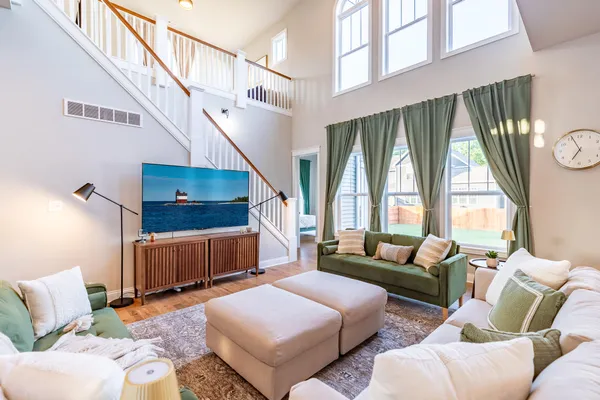 a front view of a house with a garden and deck