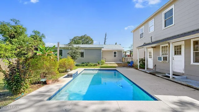 a view of a house with swimming pool and sitting area