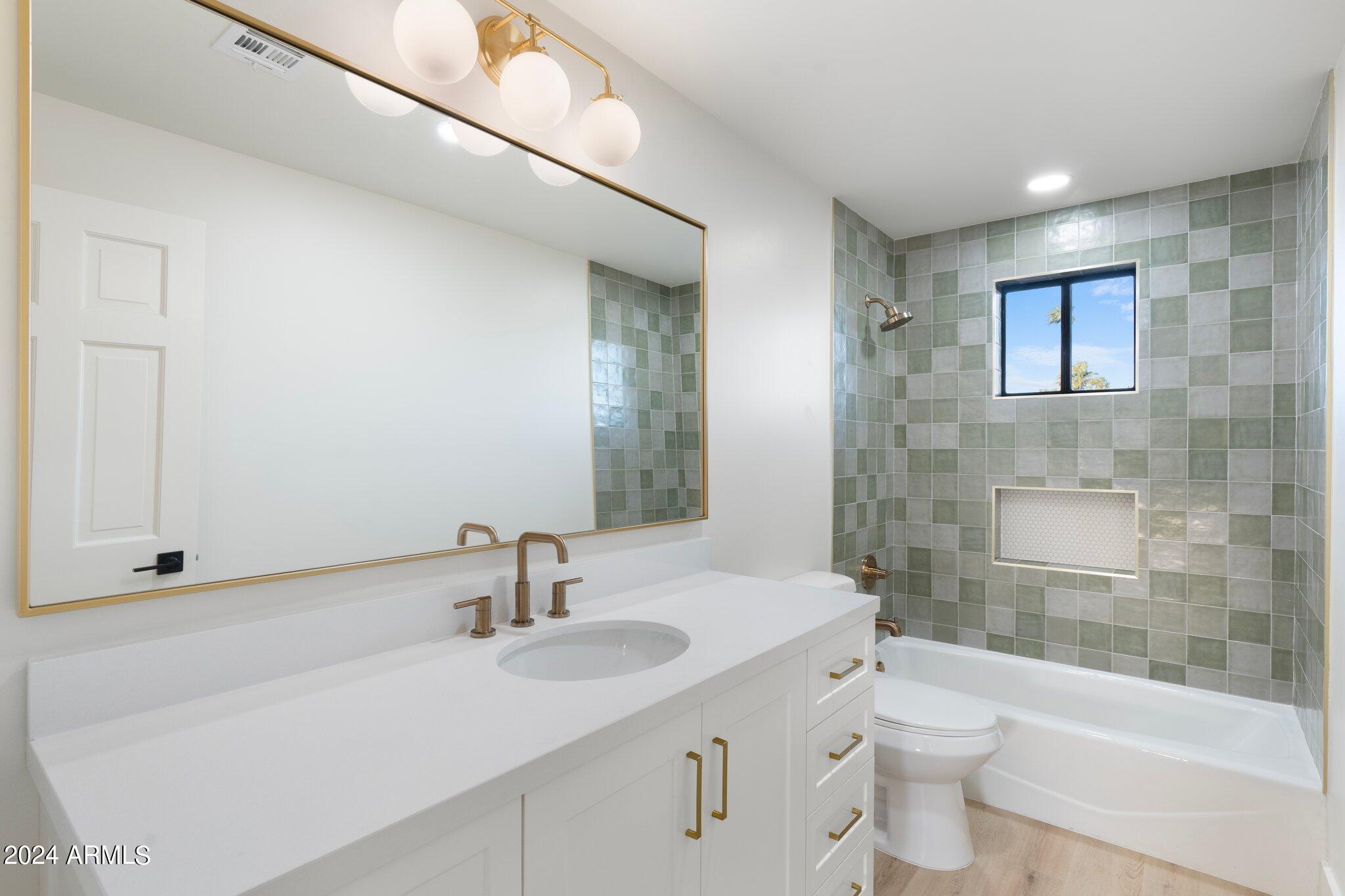 1643 West Griswold Road Phoenix, AZ 85021 - Photo 17 of 81 a bathroom with a sink a toilet and shower
