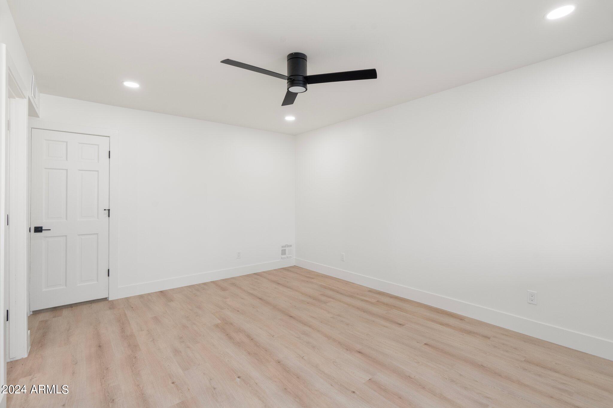 1643 West Griswold Road Phoenix, AZ 85021 - Photo 21 of 81 a view of a room with wooden floor