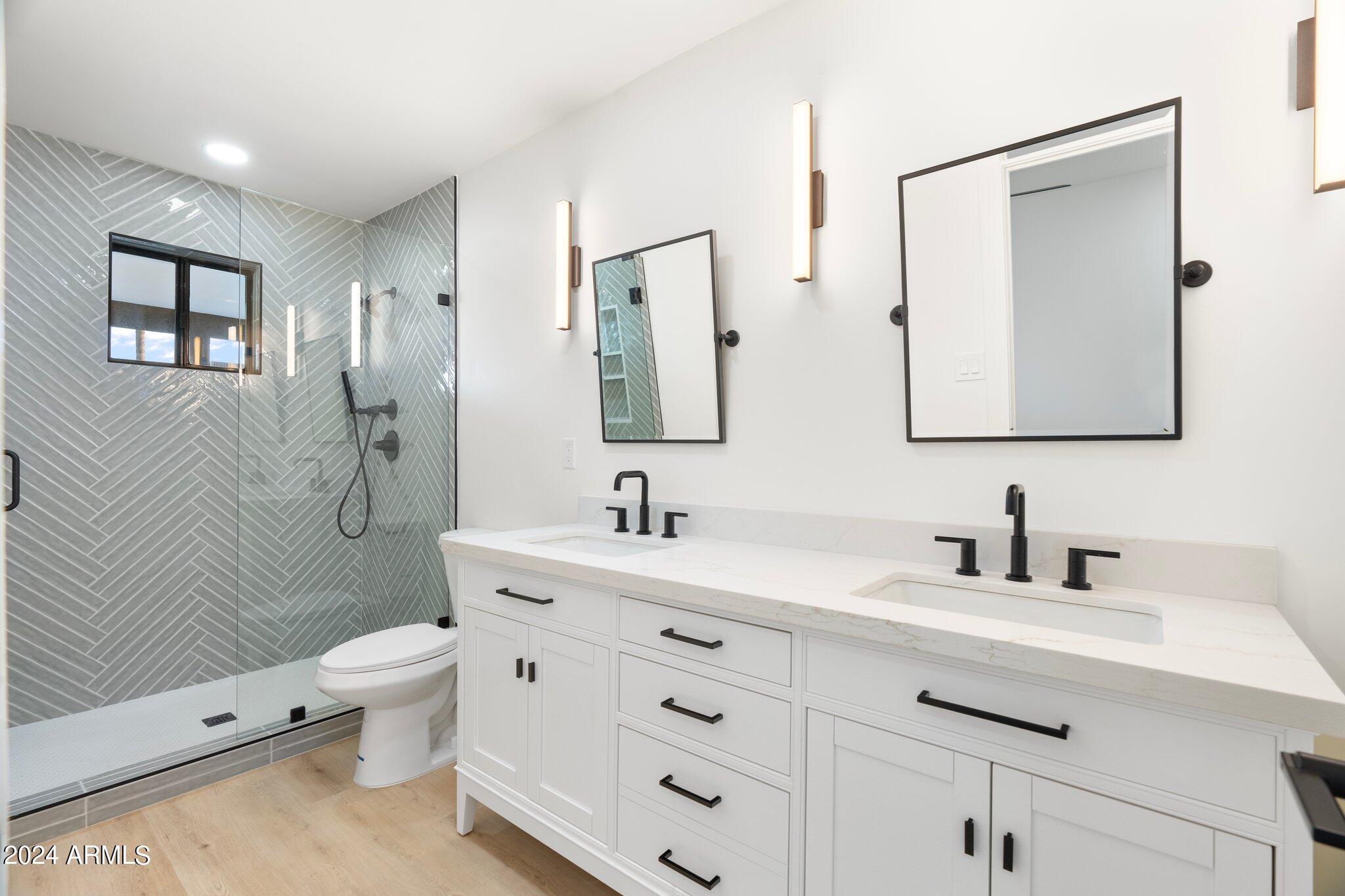 1643 West Griswold Road Phoenix, AZ 85021 - Photo 23 of 81 a bathroom with a double vanity sink toilet mirror and shower