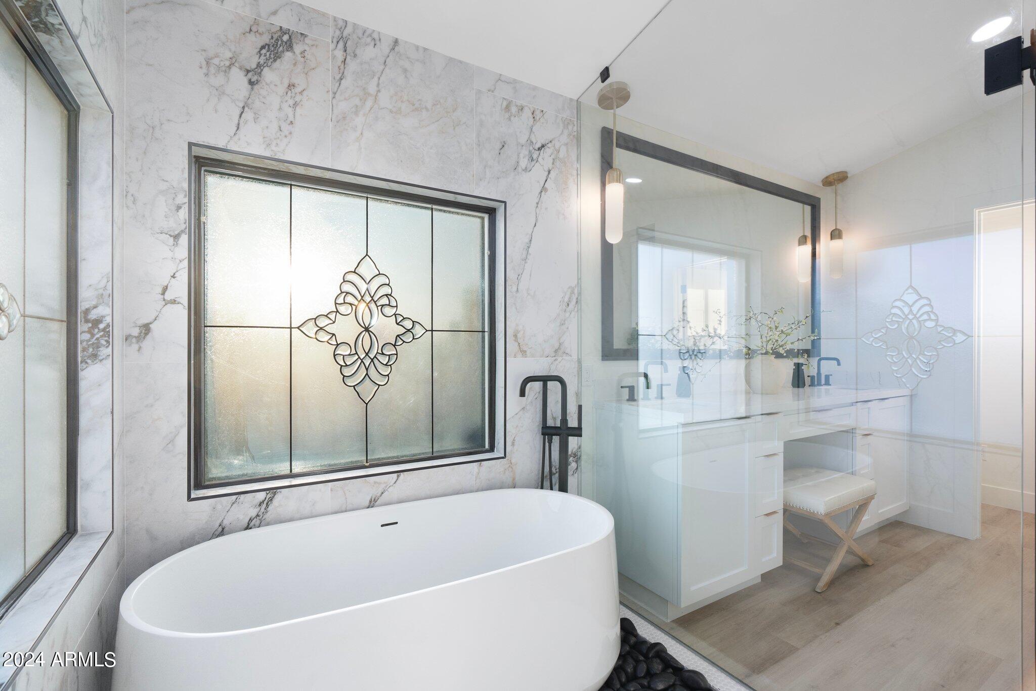 1643 West Griswold Road Phoenix, AZ 85021 - Photo 37 of 81 a white bath tub sitting next to a white sink and a mirror
