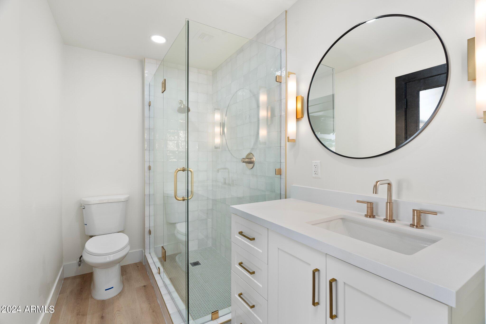 1643 West Griswold Road Phoenix, AZ 85021 - Photo 45 of 81 a bathroom with a sink a toilet and a mirror