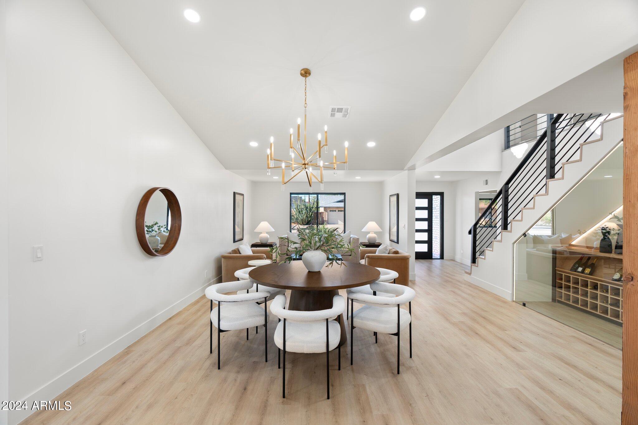 1643 West Griswold Road Phoenix, AZ 85021 - Photo 49 of 81 a dining room with furniture a chandelier and wooden floor
