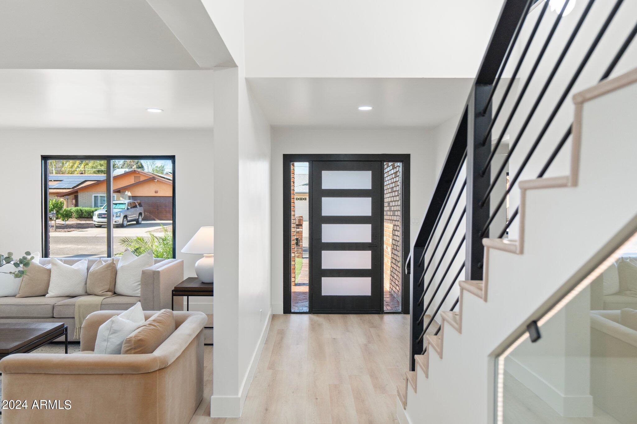 1643 West Griswold Road Phoenix, AZ 85021 - Photo 52 of 81 a living room with furniture and a floor to ceiling window