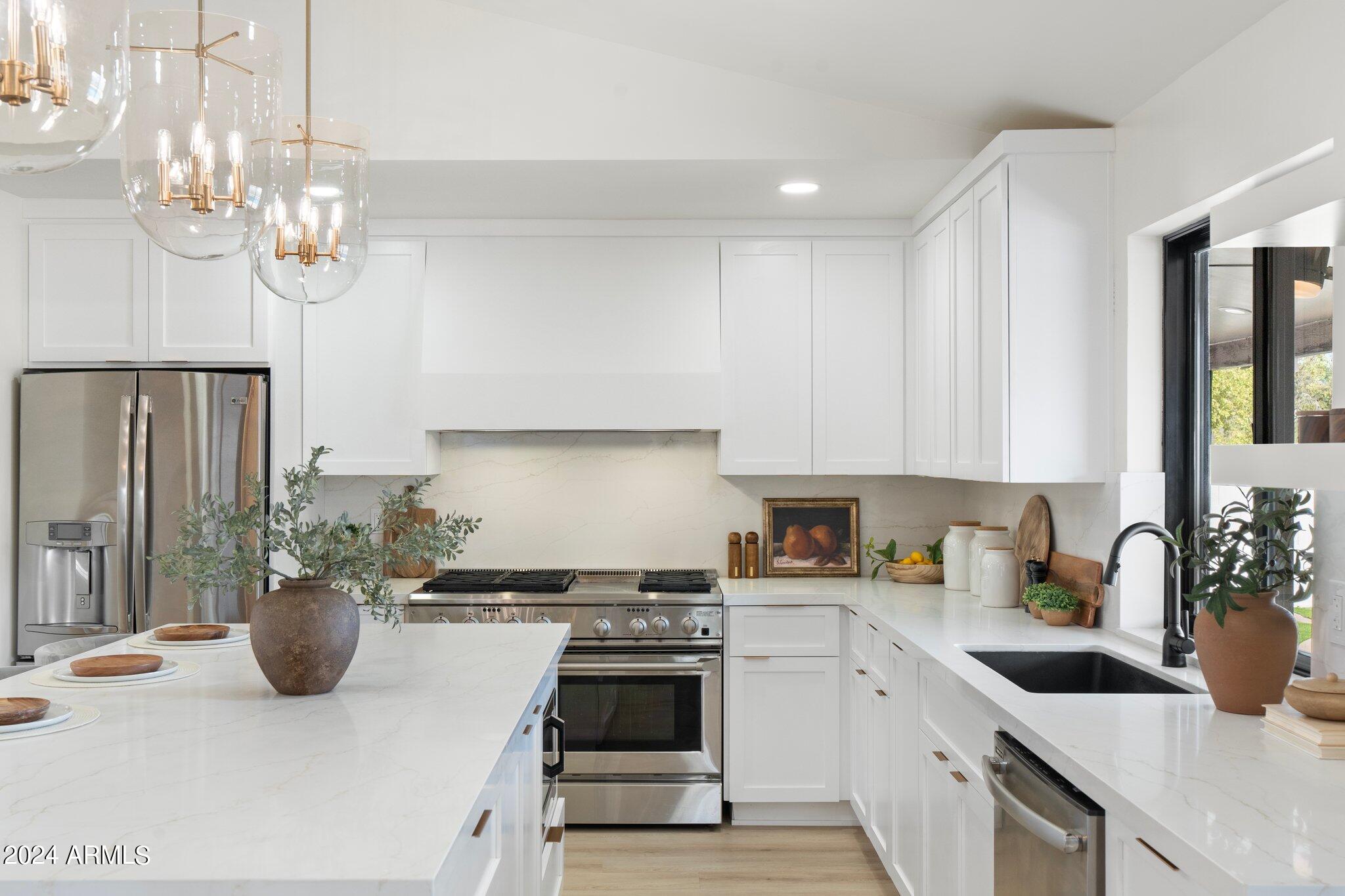 1643 West Griswold Road Phoenix, AZ 85021 - Photo 54 of 81 a kitchen with a sink a stove and cabinets