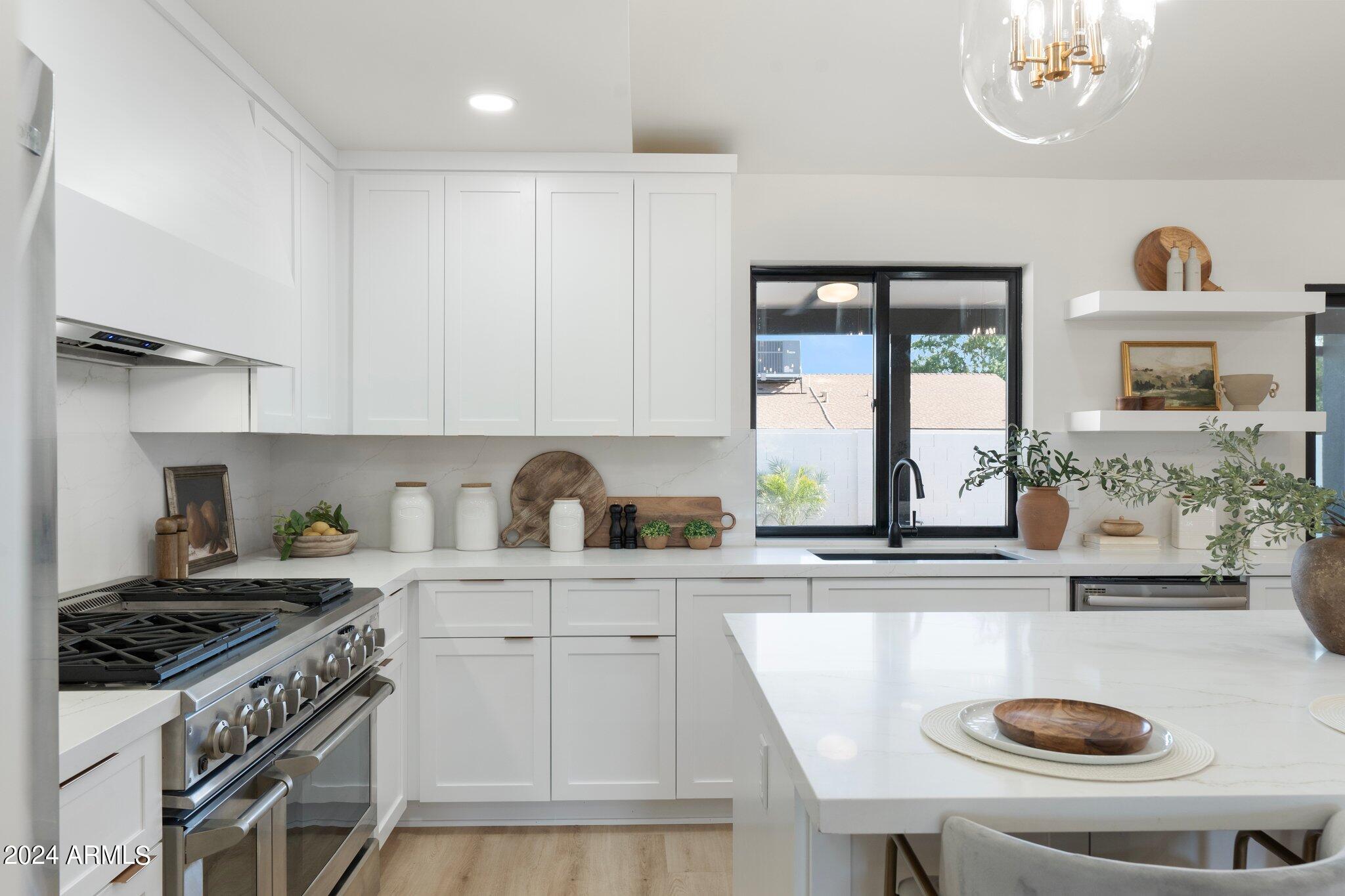 1643 West Griswold Road Phoenix, AZ 85021 - Photo 55 of 81 a kitchen with kitchen island granite countertop a sink a stove and a refrigerator
