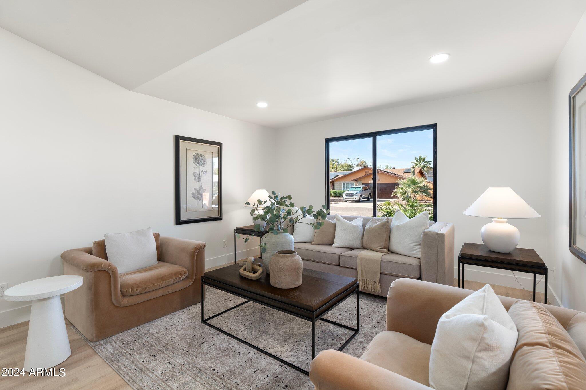1643 West Griswold Road Phoenix, AZ 85021 - Photo 60 of 81 a living room with furniture and a potted plant