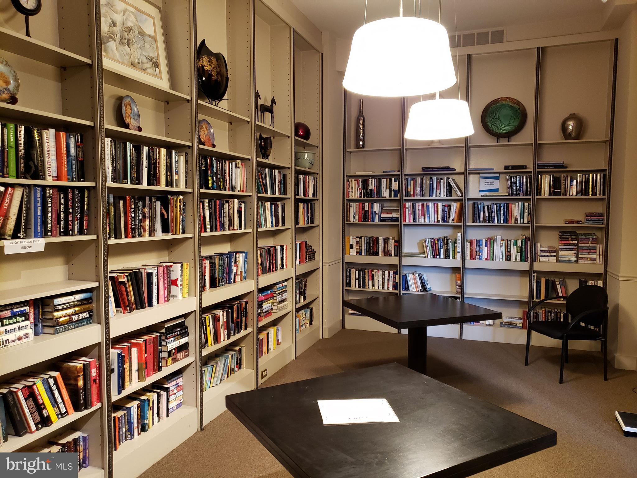 a view of a workspace with bookshelf