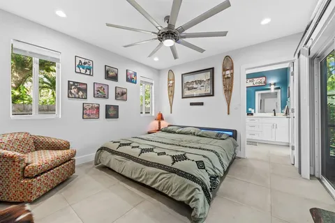 a bedroom with a bed couches and a window