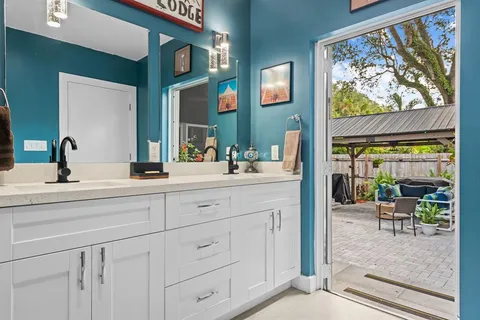 a bathroom with a sink a mirror and a window