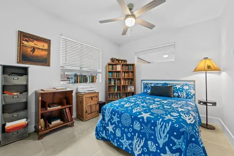 a bedroom with a bed and a book shelf