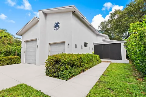 a view of a house with a yard and a garage