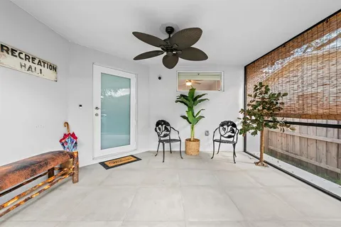 a dining room with furniture and a window
