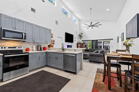 a kitchen with a sink stove and microwave