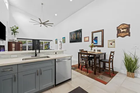 a view of kitchen with sink dining table and chairs