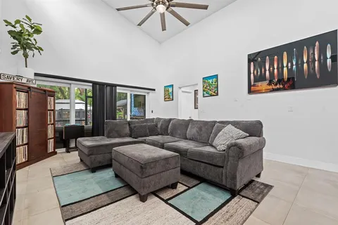 a living room with furniture and a book shelf