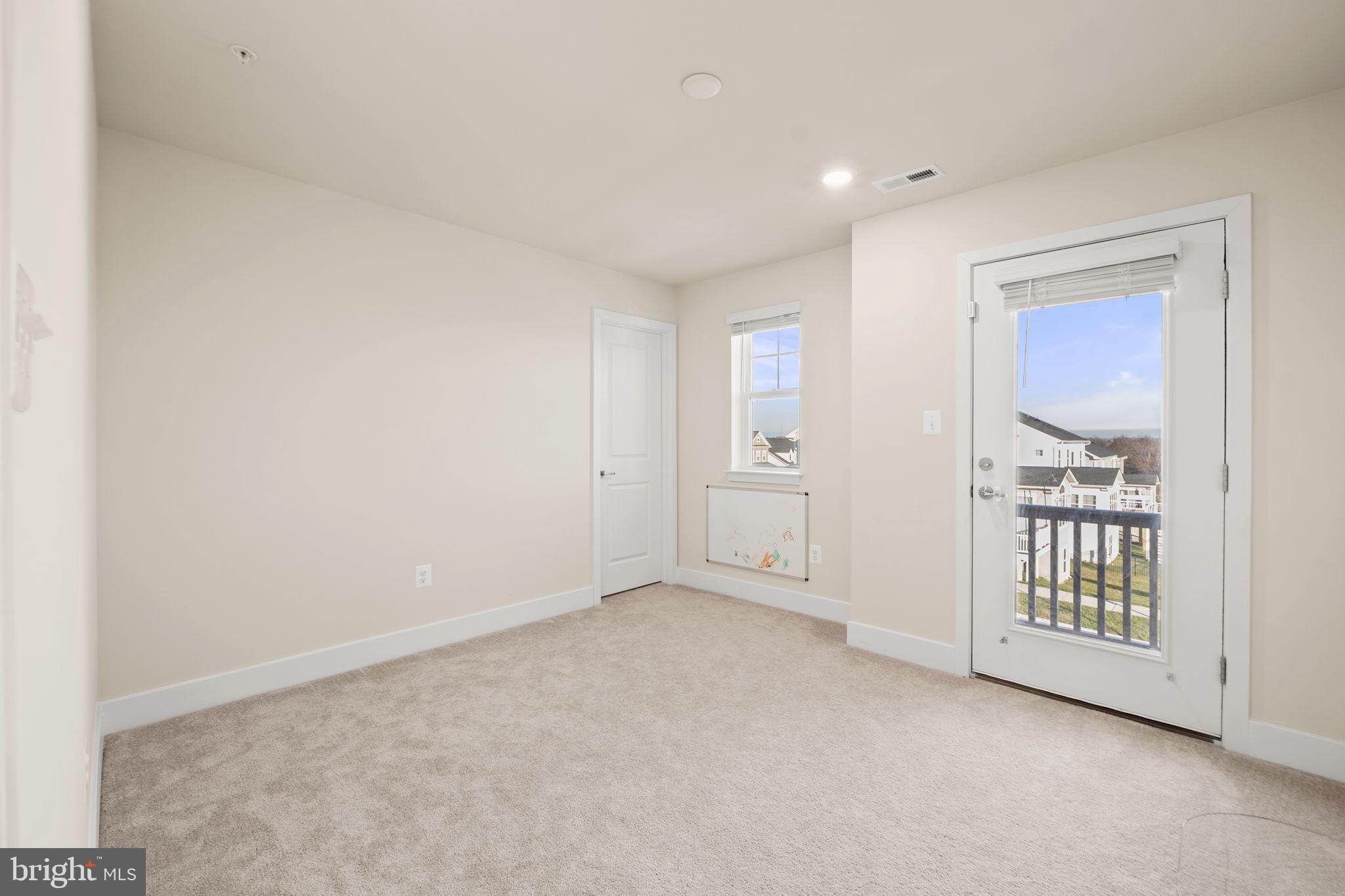 1281 Backbone Way Frederick, MD 21702 - Photo 28 of 40 an empty room with windows and closet
